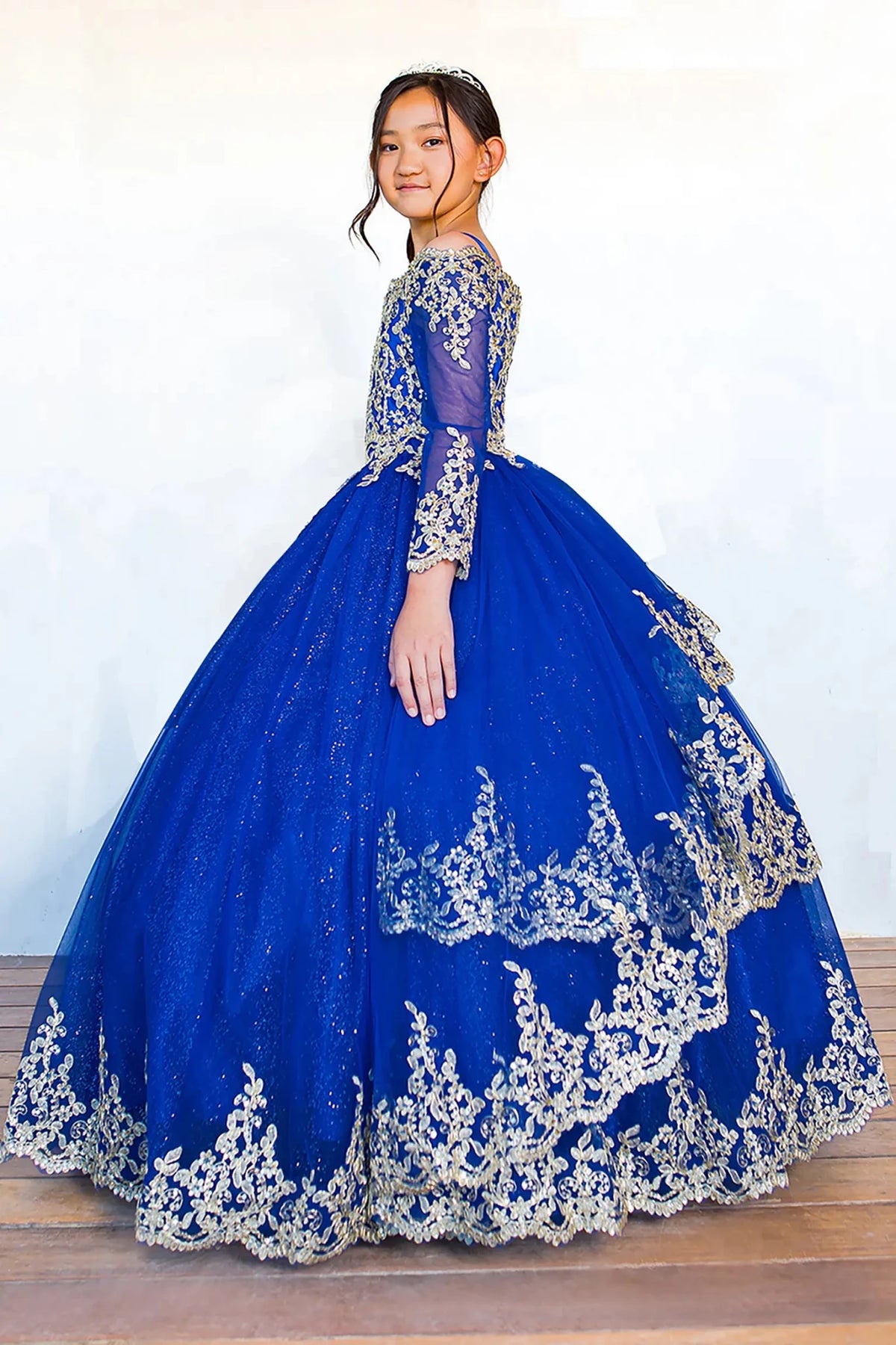 Royal blue mini quince dress with long sleeve off-shoulder glitter tulle and gold lace back detail.