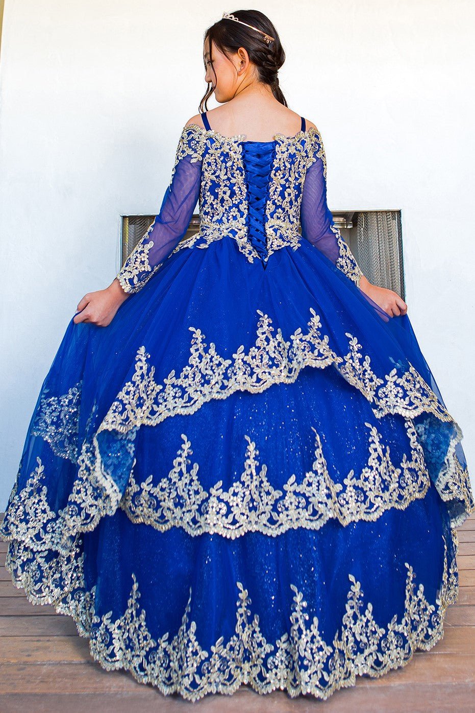 Royal blue mini quince dress with long sleeve off-shoulder glitter tulle and front detail.