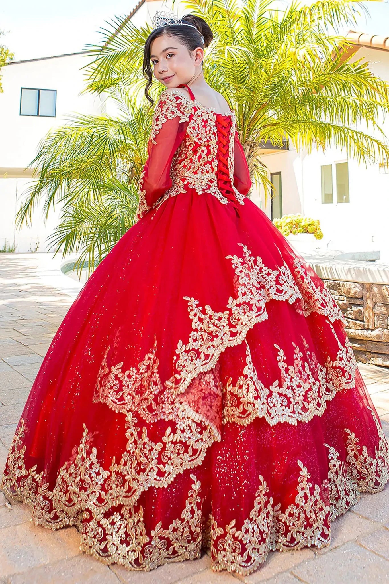 Red mini quince dress with long sleeve off-shoulder glitter tulle and gold lace back view.