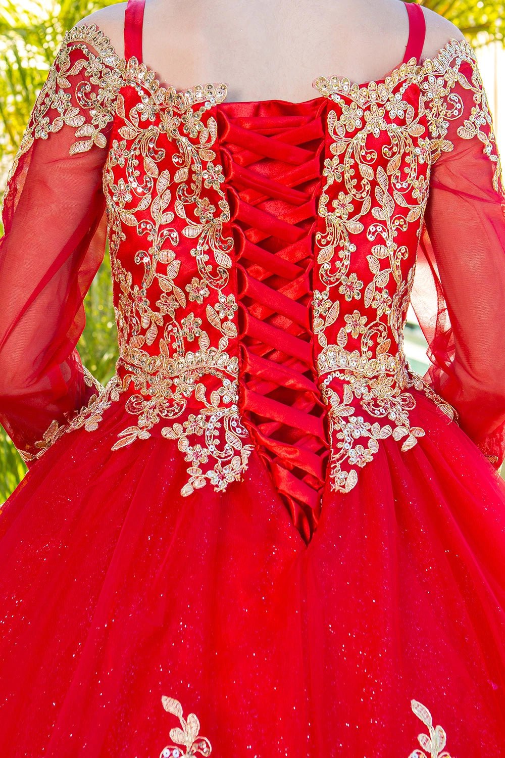 Displayed in a back detail, the Red mini quince dress has lace-up back bordered by gold lace and sheer sleeves.