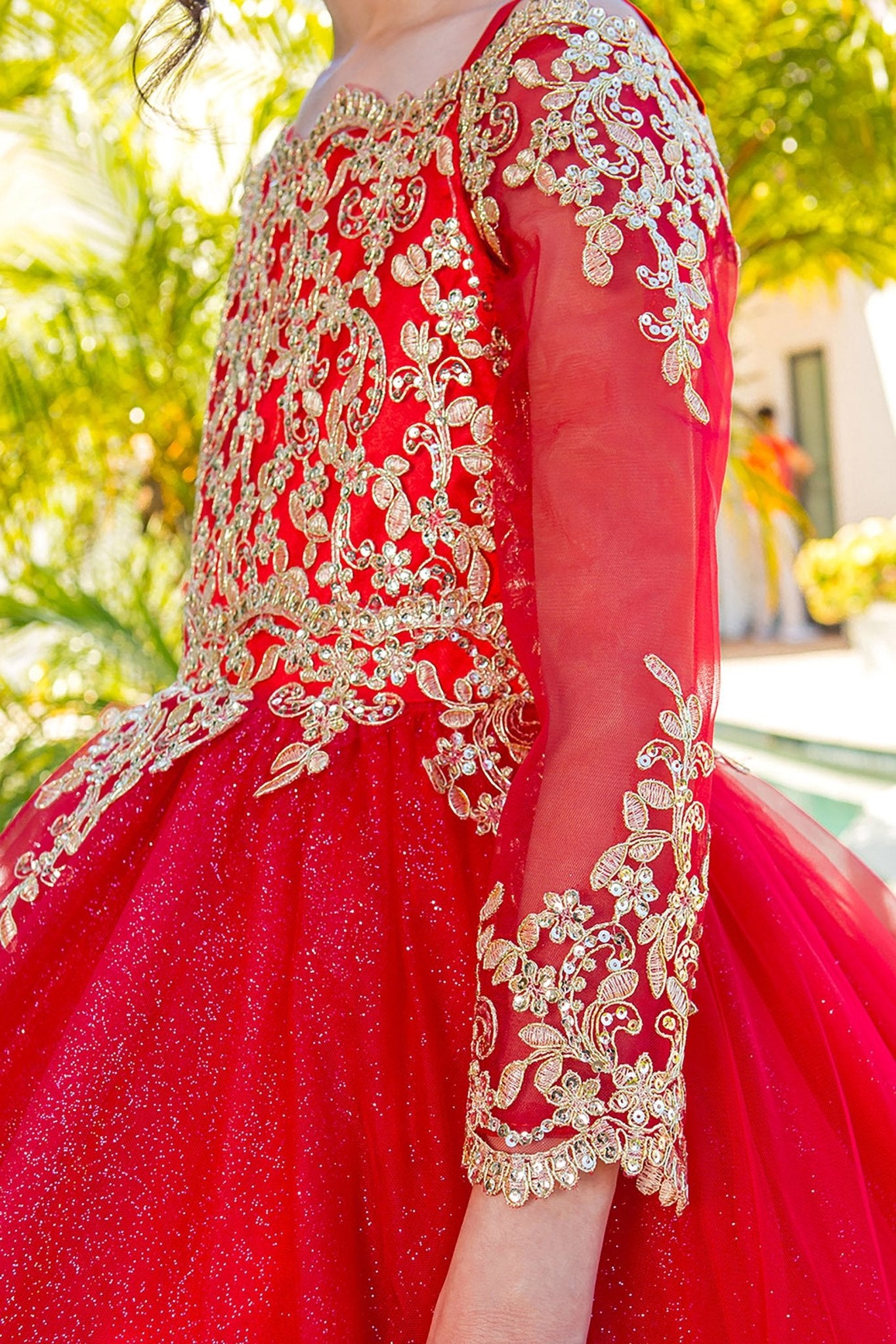 Red mini quince dress with long sleeve off-shoulder glitter tulle and side zoom detail.