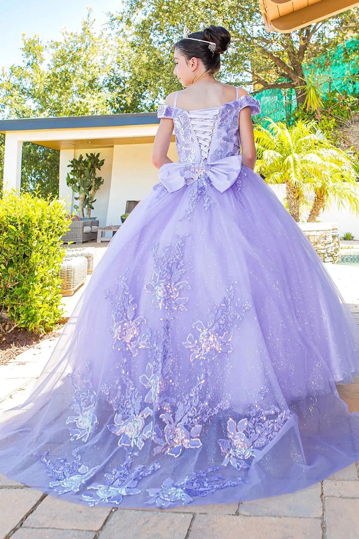 Lilac back view kids mini quinceañera mini quince dress with off-shoulder lace-up corset, 3D applique and long tulle train.