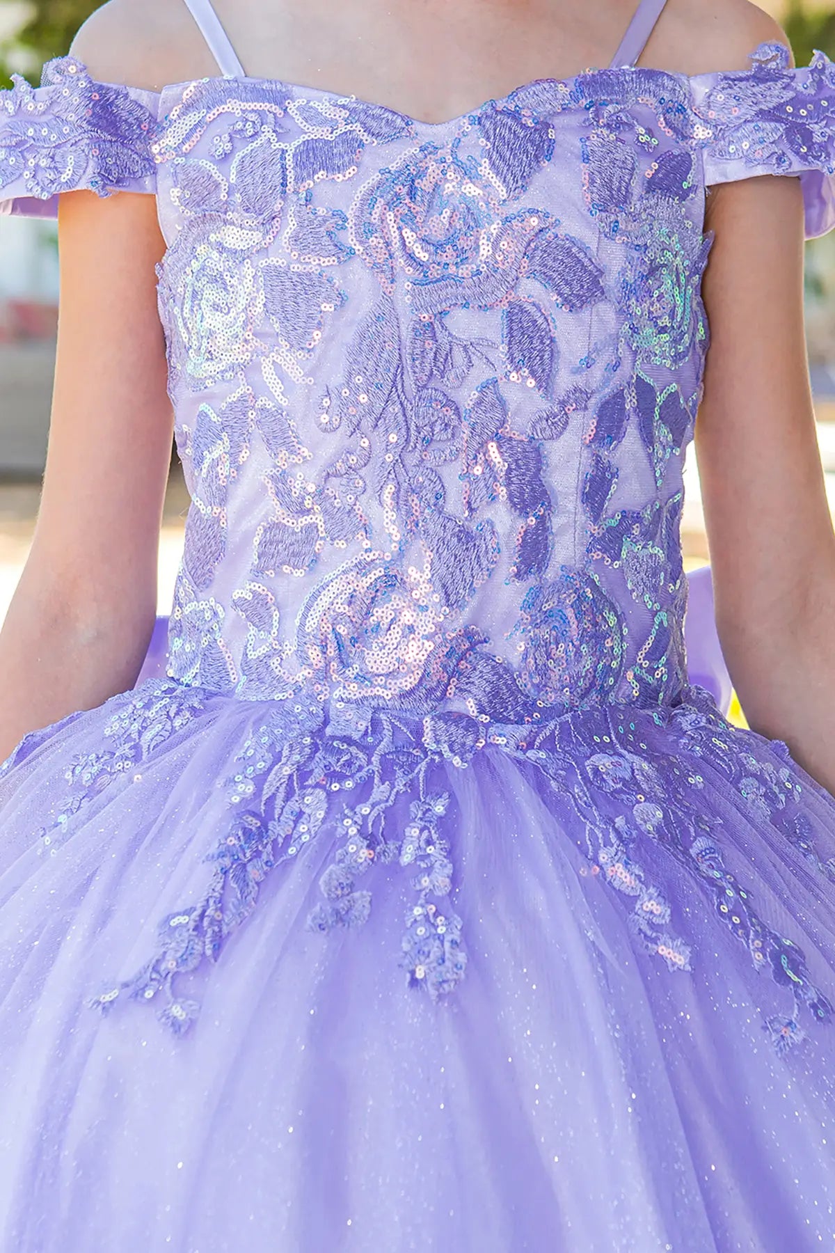 Lilac front view kids mini quinceañera mini quince dress with off-shoulder lace detailing and 3D floral applique.