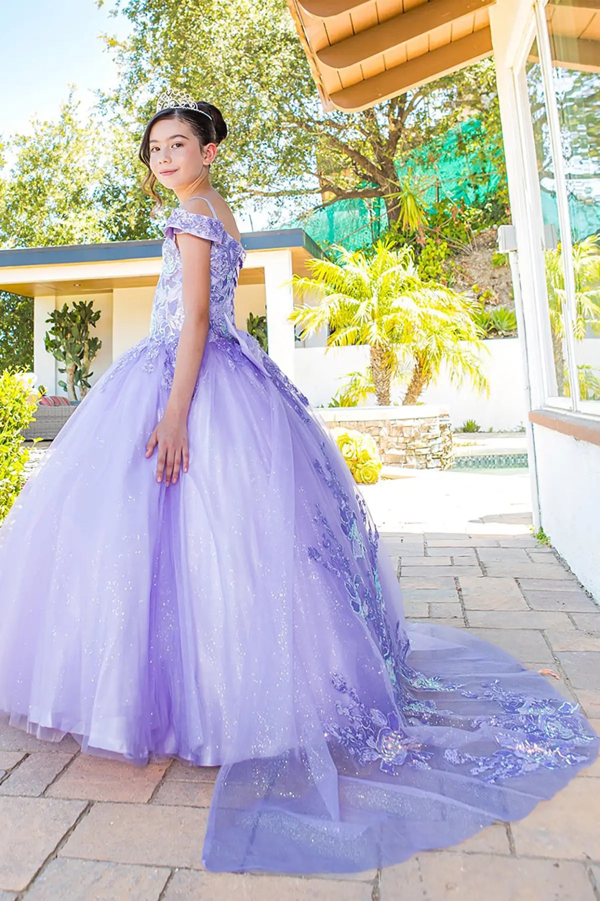 Lilac front view kids mini quinceañera mini quince dress with off-shoulder lace, 3D floral applique and layered tulle skirt.