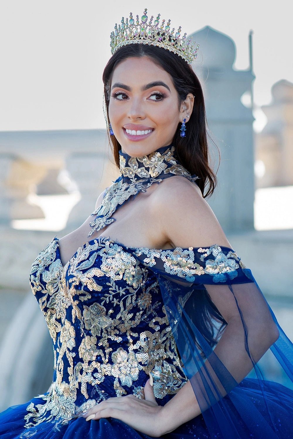 Shown in a bodice detail, the Navy quinceañera dress has gold floral collar, shoulder straps and embroidered bodice.