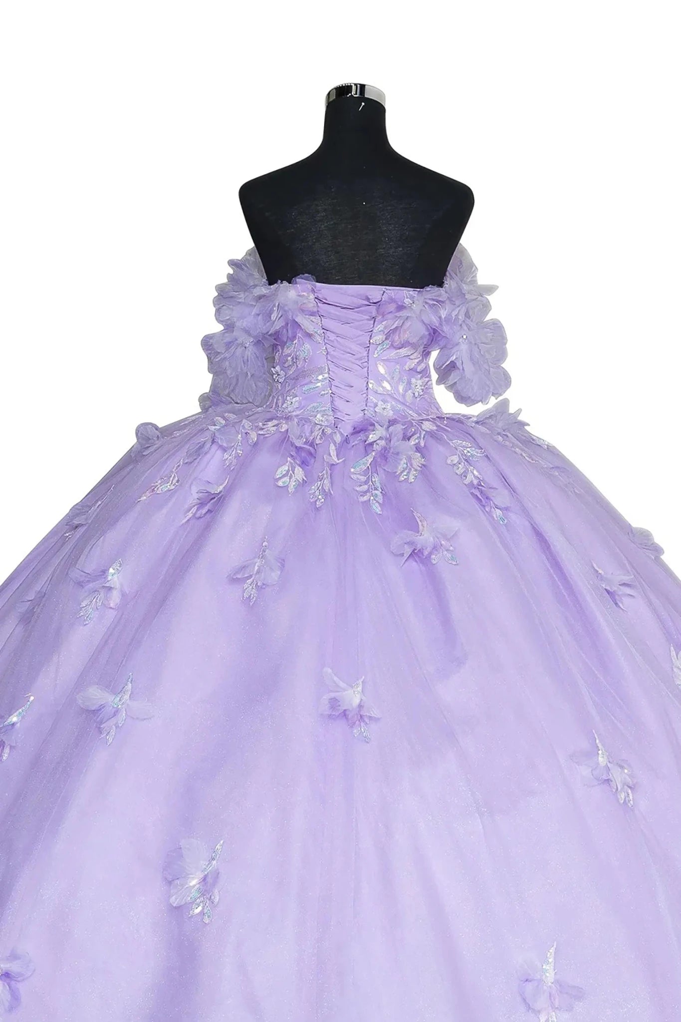 Back view of a mannequin wearing a lilac quinceanera dress with rainbow embroidery, sequin ruffle flowers, and crown detail