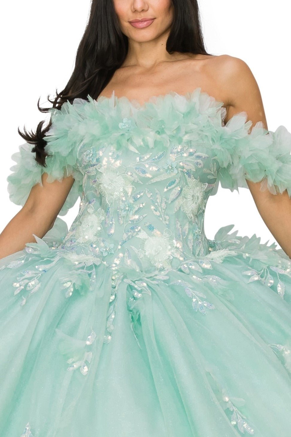 Full view of a woman wearing an aqua blue quinceanera dress with rainbow embroidery, sequin ruffle flowers, and leaf accents