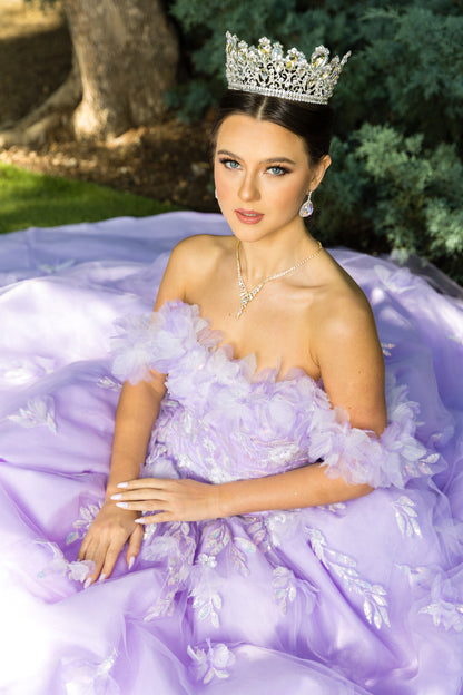 Lilac Quinceanera | Off-shoulder Rainbow Embroidered Sequin Ruffle Flower Leaves accent gown - front view of woman wearingdress and crown looking into the camera