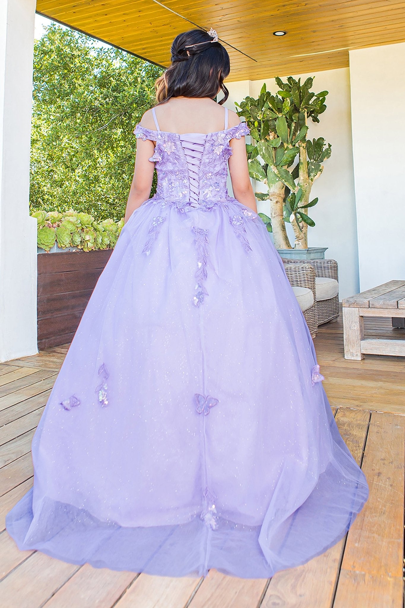 Kid wearing lilac mini quince dress with 3D butterfly applique detachable sleeves glitter tulle back detail