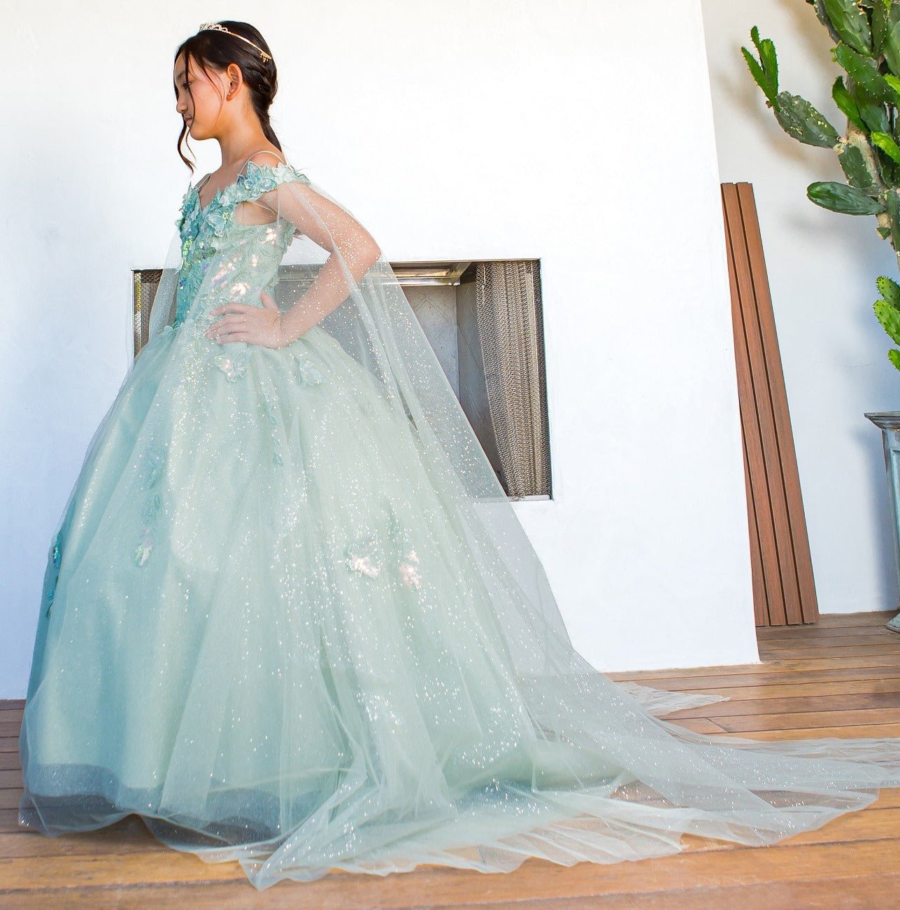 Portrait view of a sage mini quince dress with 3D butterfly applique glitter tulle skirt.