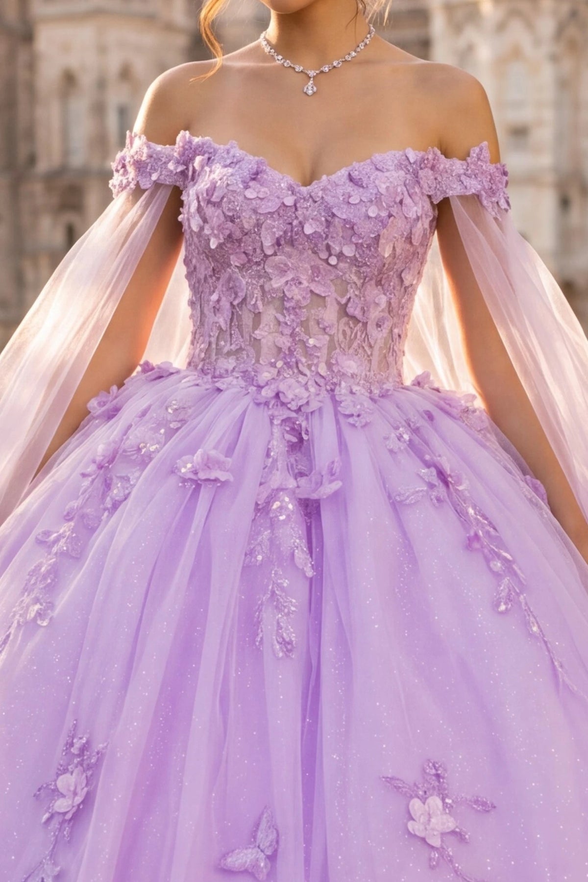 lavender ball gown with 3D floral appliqué, a sheer tulle bodice, and a voluminous tulle skirt with butterfly embellishments