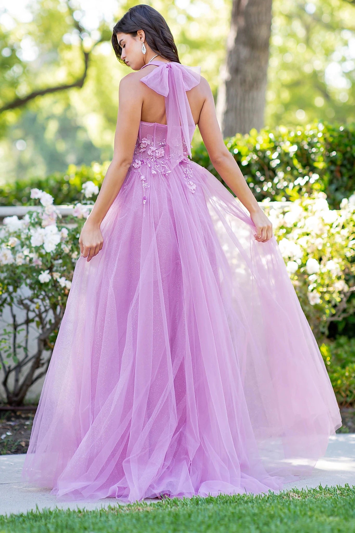 Pink prom dress styled with halter neck tie closure
