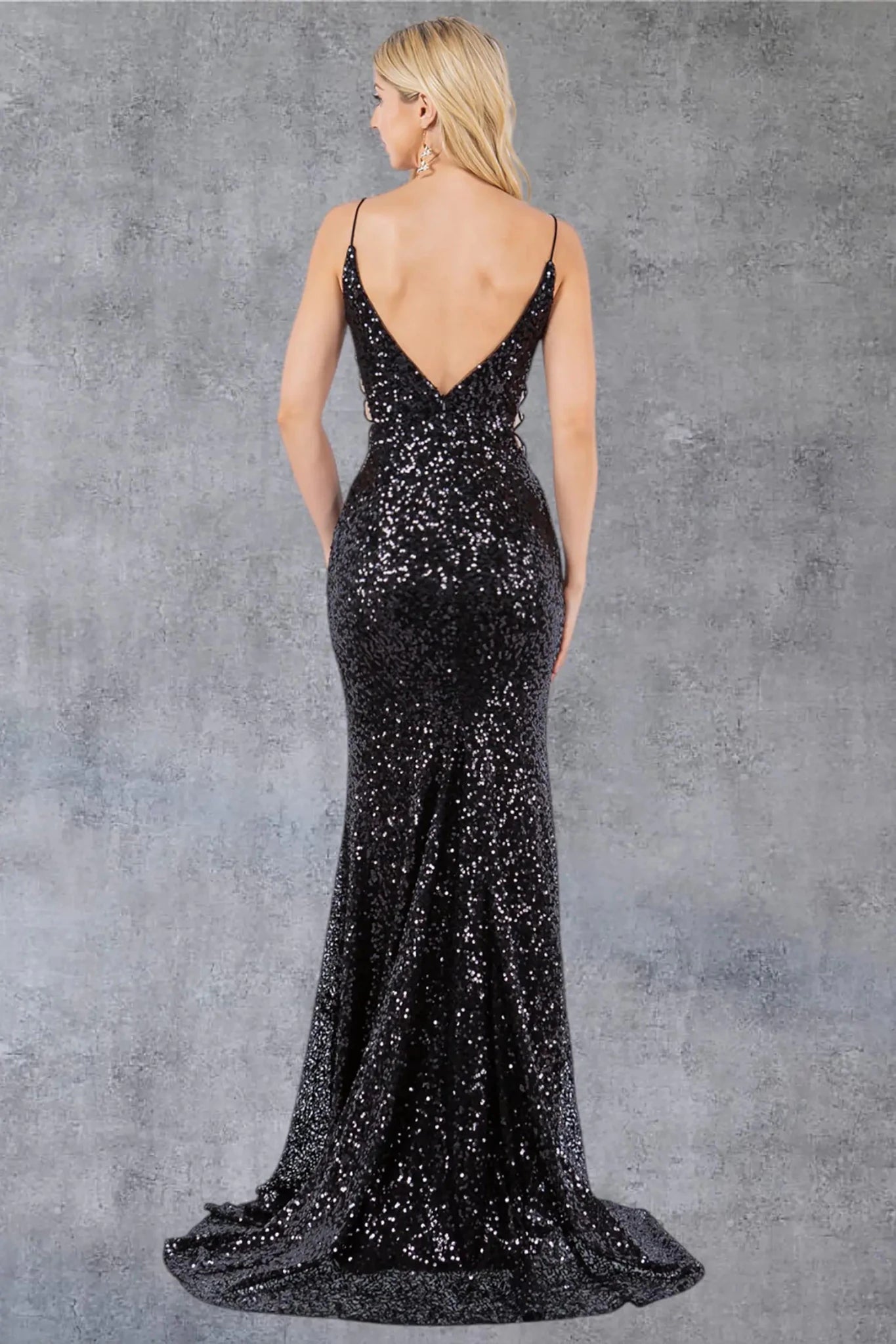 A full back view of a woman wearing a black sequin formal dress with a zipper closure and fitted silhouette.