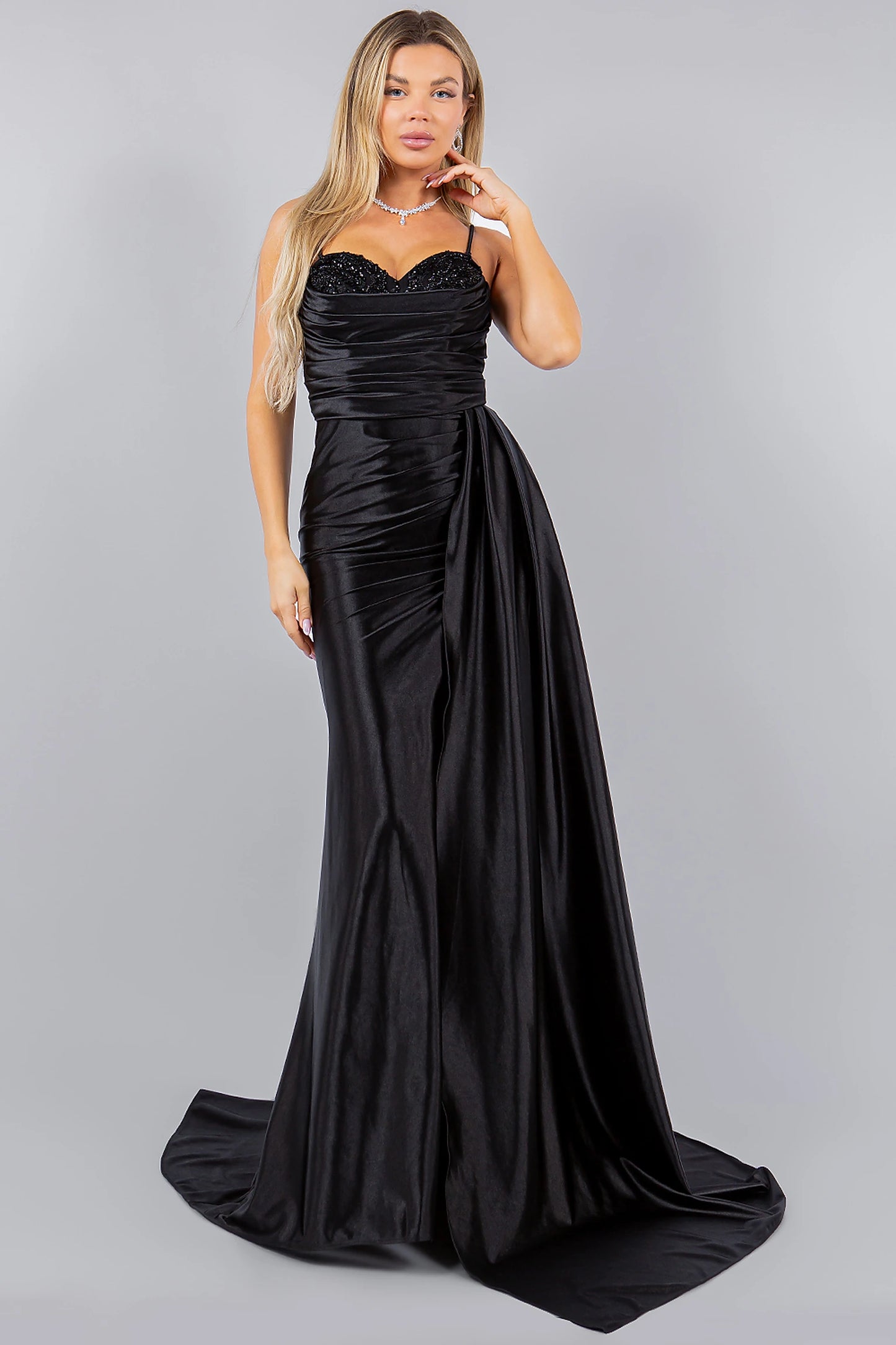 Black evening dress styled with ruched detailing at waistline