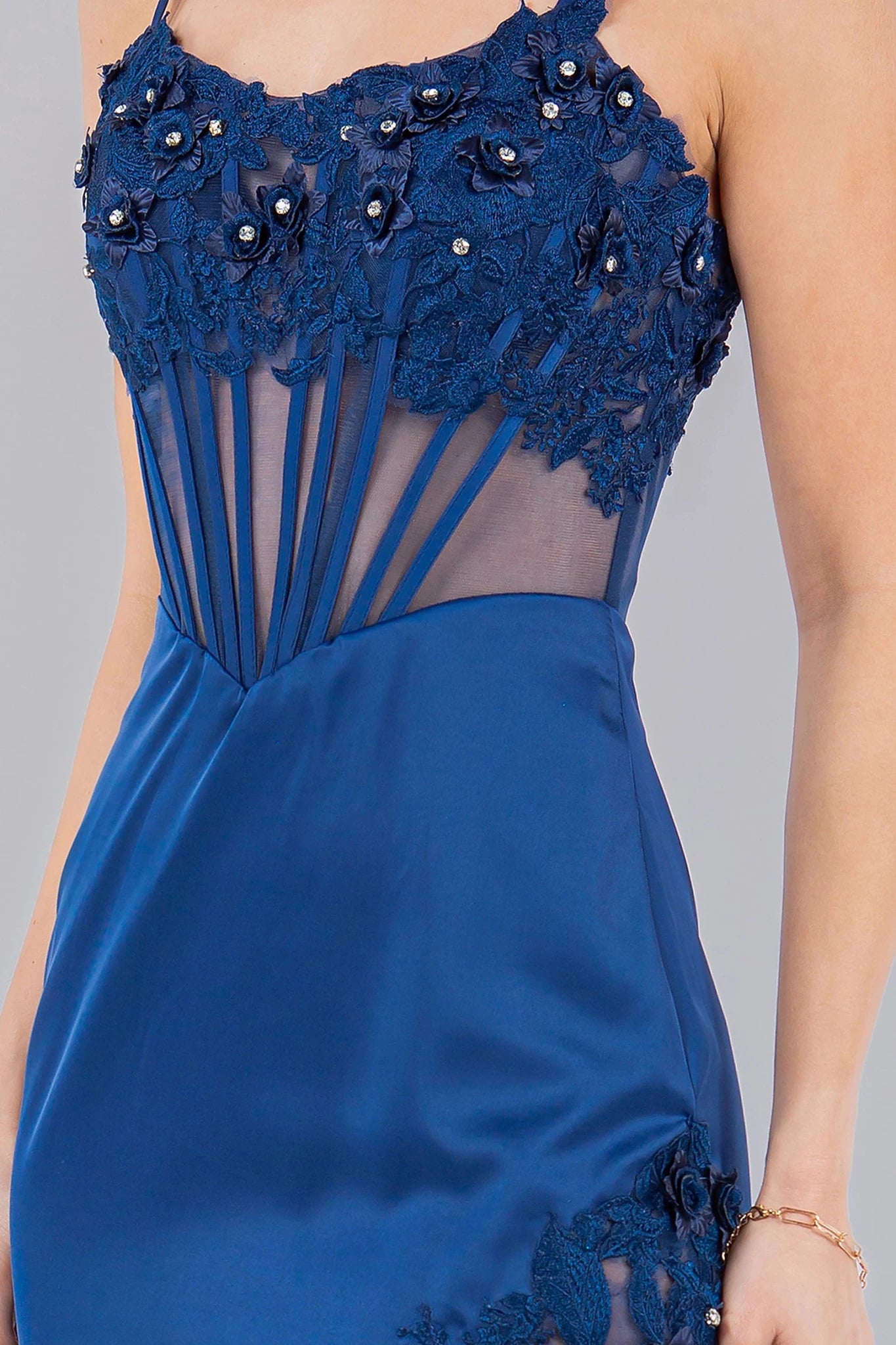 Blue spaghetti strap gown featuring fitted silhouette with structured corset design