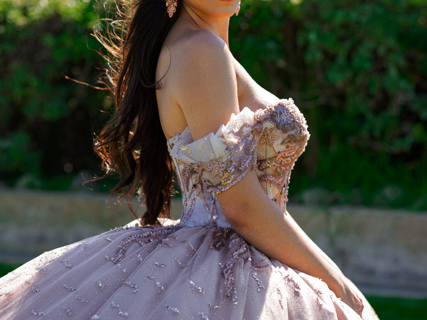 Quinceanera | Mauve Bead-Embroidered & Sequin Appliques Bodice Off-shoulder w/ Multiple Glitter Tulle Ballgown with Train - zoomed in side view of woman wearing dress showing shoulder straps