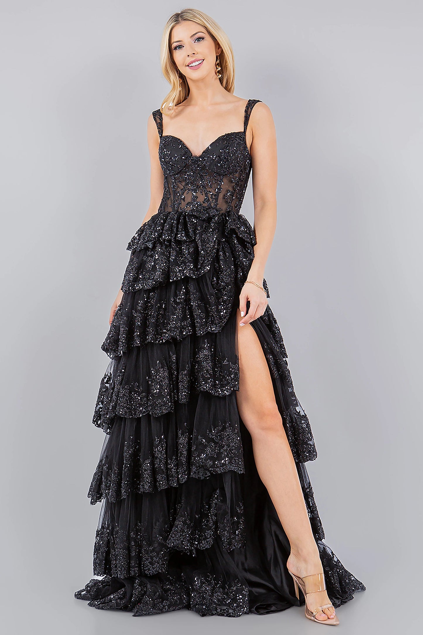 Black evening dress showcasing ruffled tiered skirt with high side slit