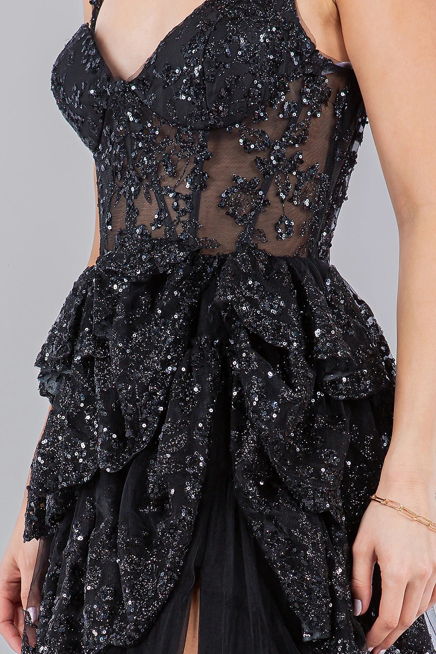 Black evening dress featuring sheer panels with sequin and bead accents