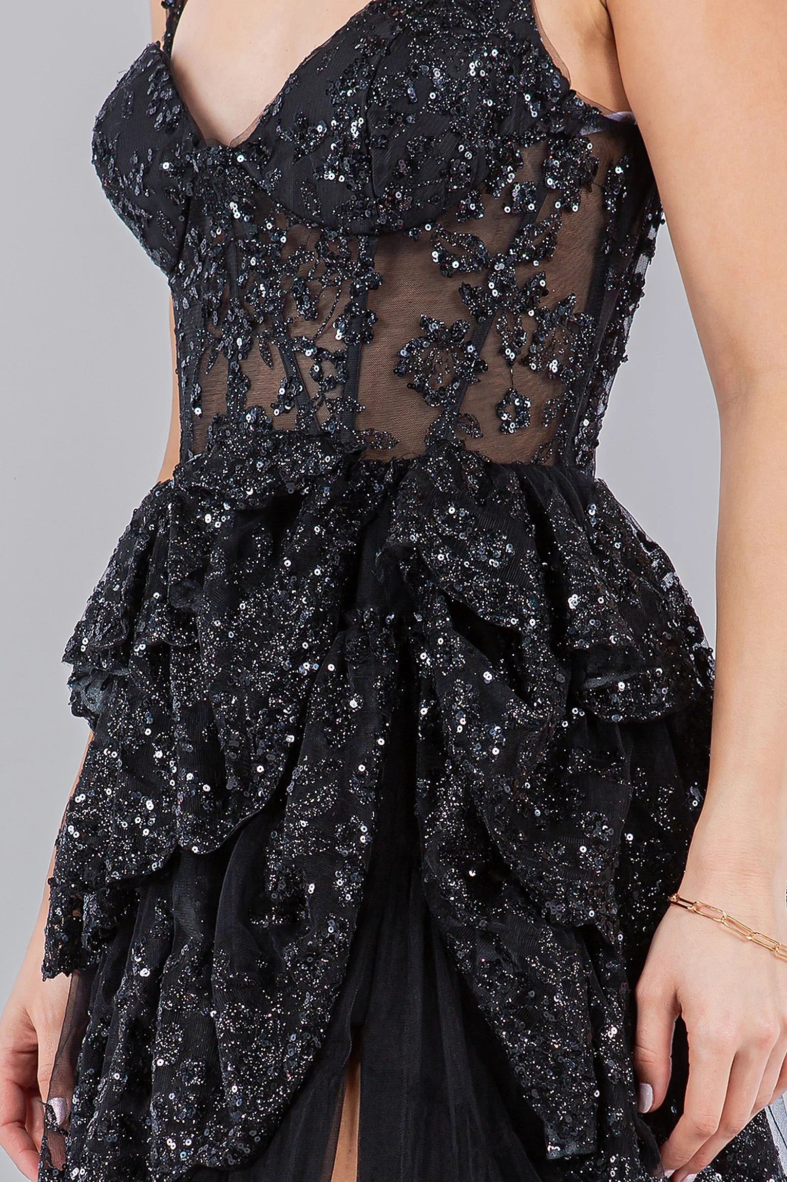 Black evening dress featuring sheer panels with sequin and bead accents