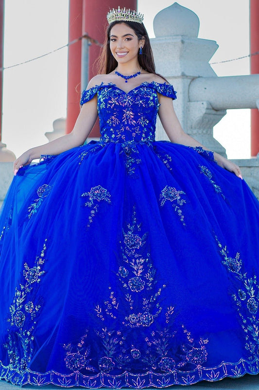 Woman in a blue quinceañera dress with floral embroidery 