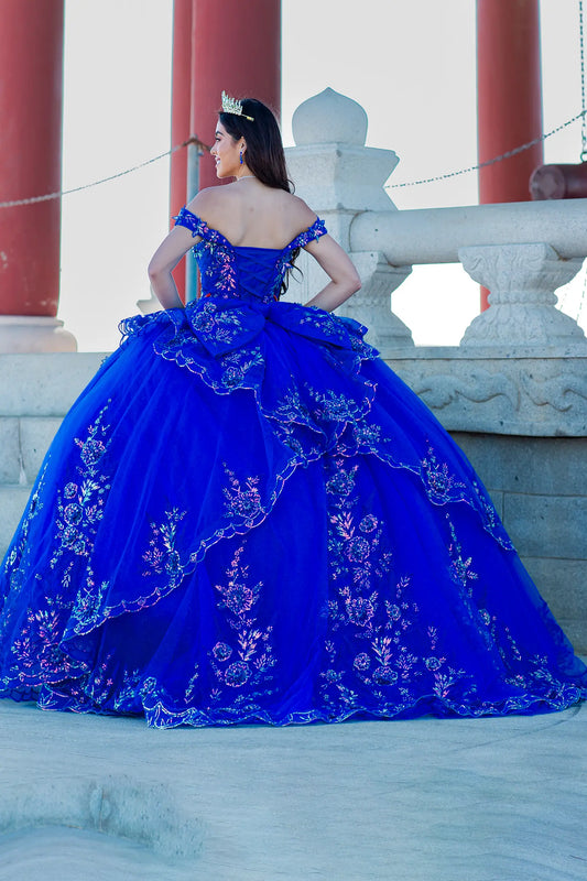 Woman in a blue embroidered quinceañeras dress with long train
