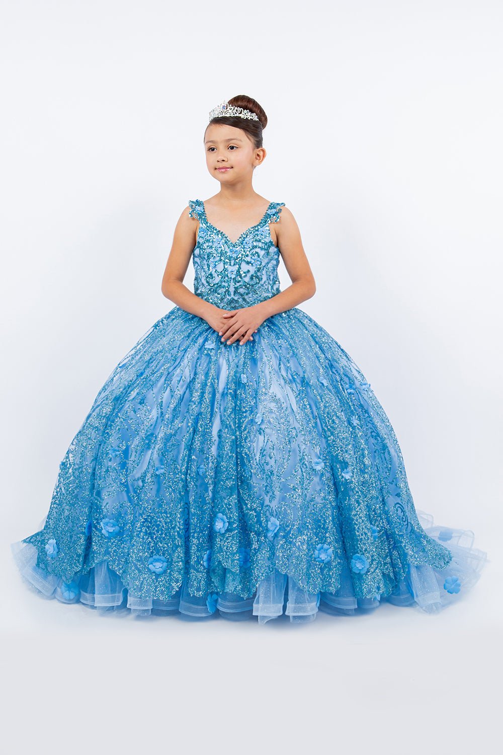 Front view of a kid wearing blue mini quince dress with ombre tulle layers lace applique embroidery and sweep train