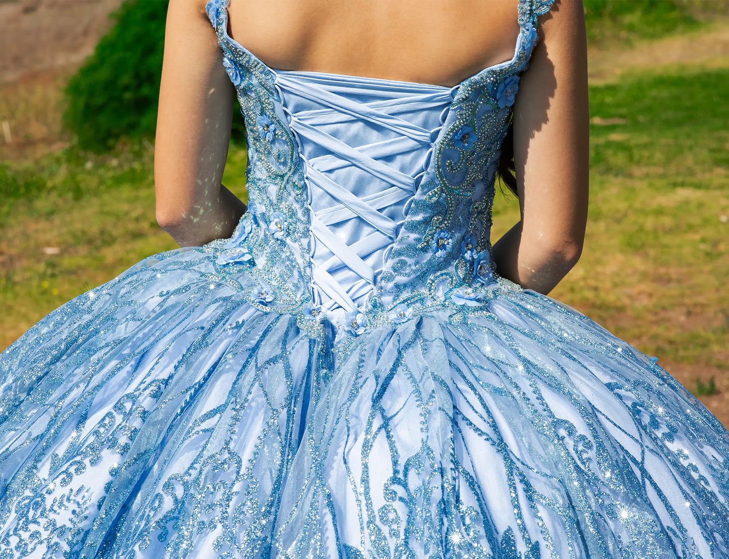 Light blue embroidered dress with a blurred natural background