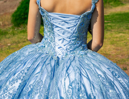 Light blue embroidered dress with a blurred natural background