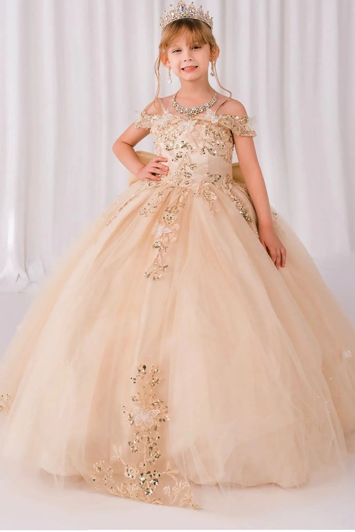 Champagne front view kids mini quinceañera mini quince dress with off-shoulder butterfly bead embroidery, glitter tulle and sweep train.