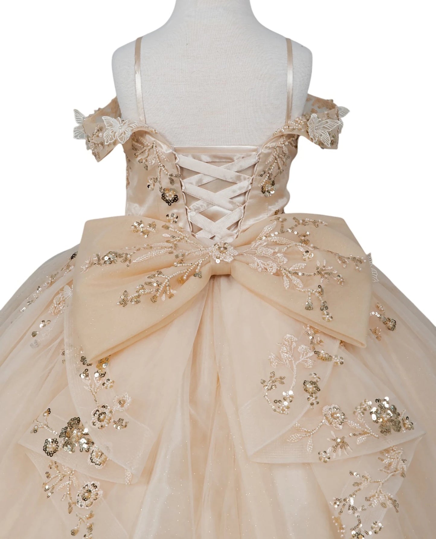Champagne front view kids mini quinceañera mini quince dress with floral lace embellishments and glitter tulle skirt.