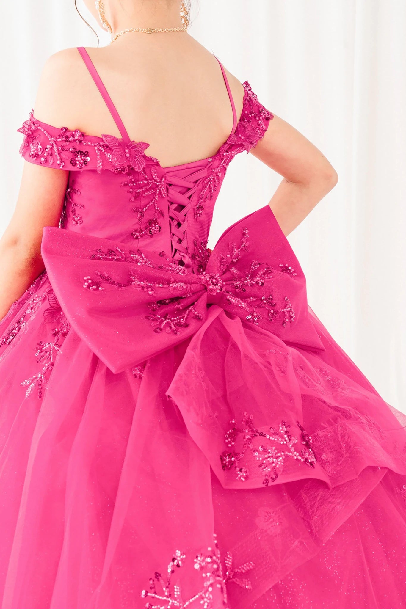 Fuchsia front view kids mini quinceañera ball gown with bead embroidery, floral lace and glitter tulle skirt