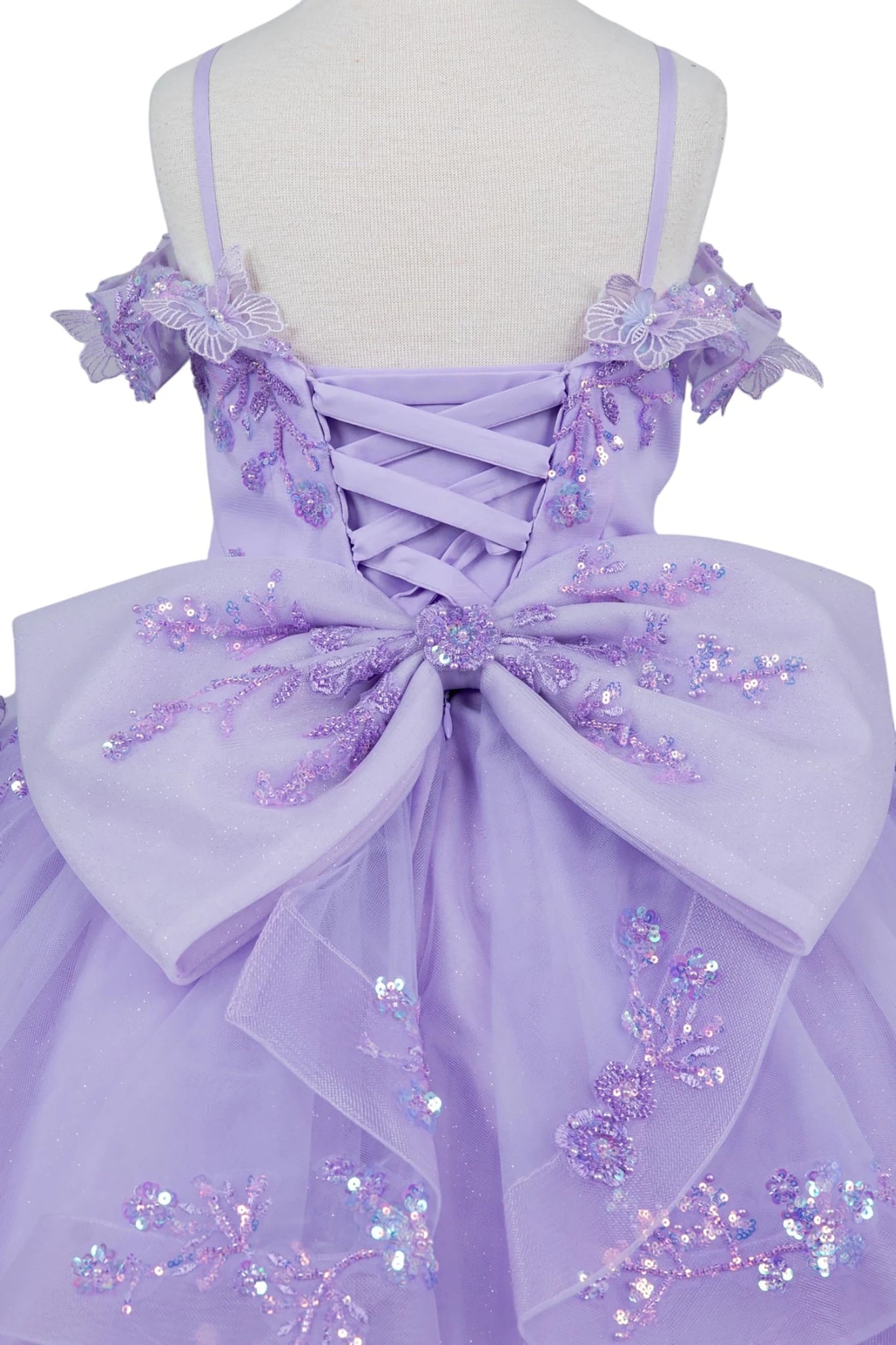 Lilac front view kids mini quinceañera mini quince dress with bead embroidered butterfly applique and floral lace.