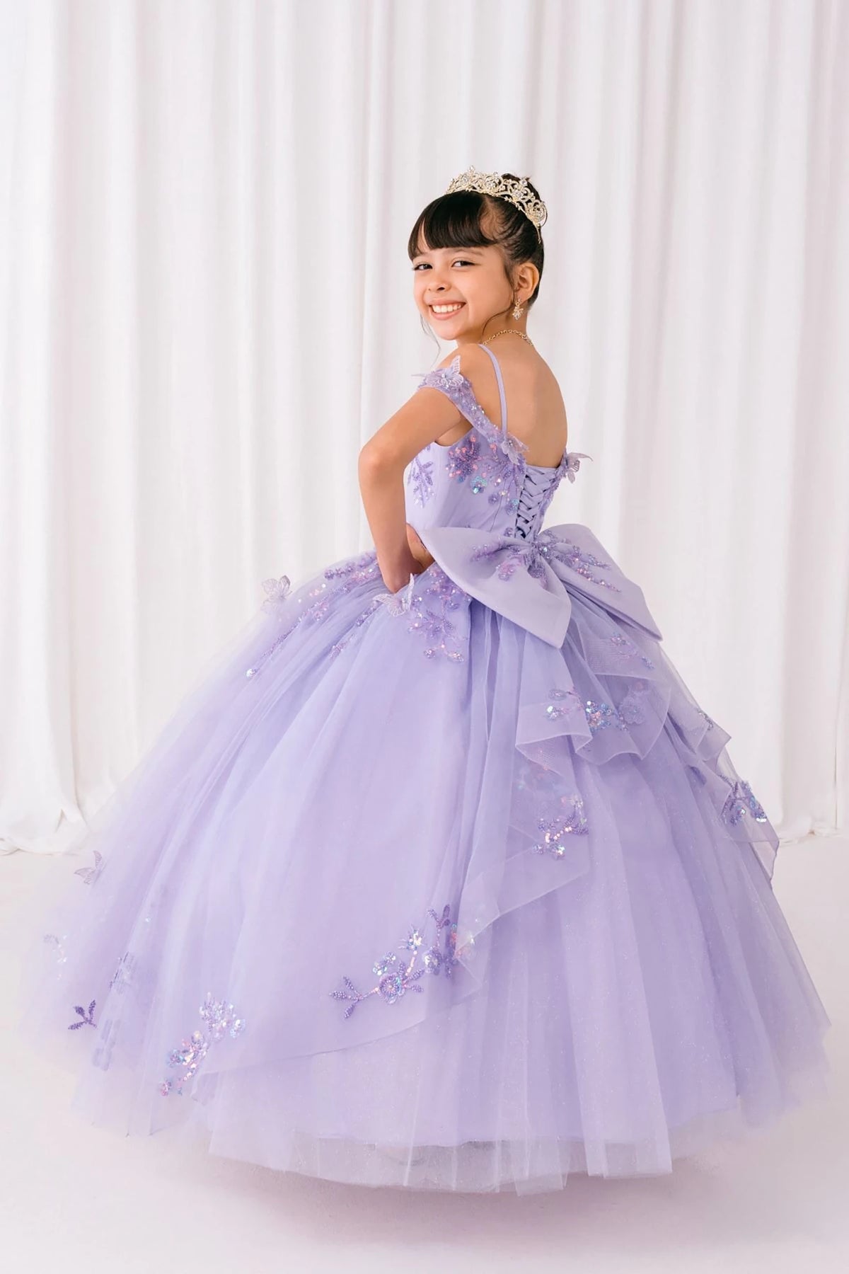 Lilac front view kids mini quinceañera mini quince dress with bead embroidered butterfly applique, floral lace and sweep train.