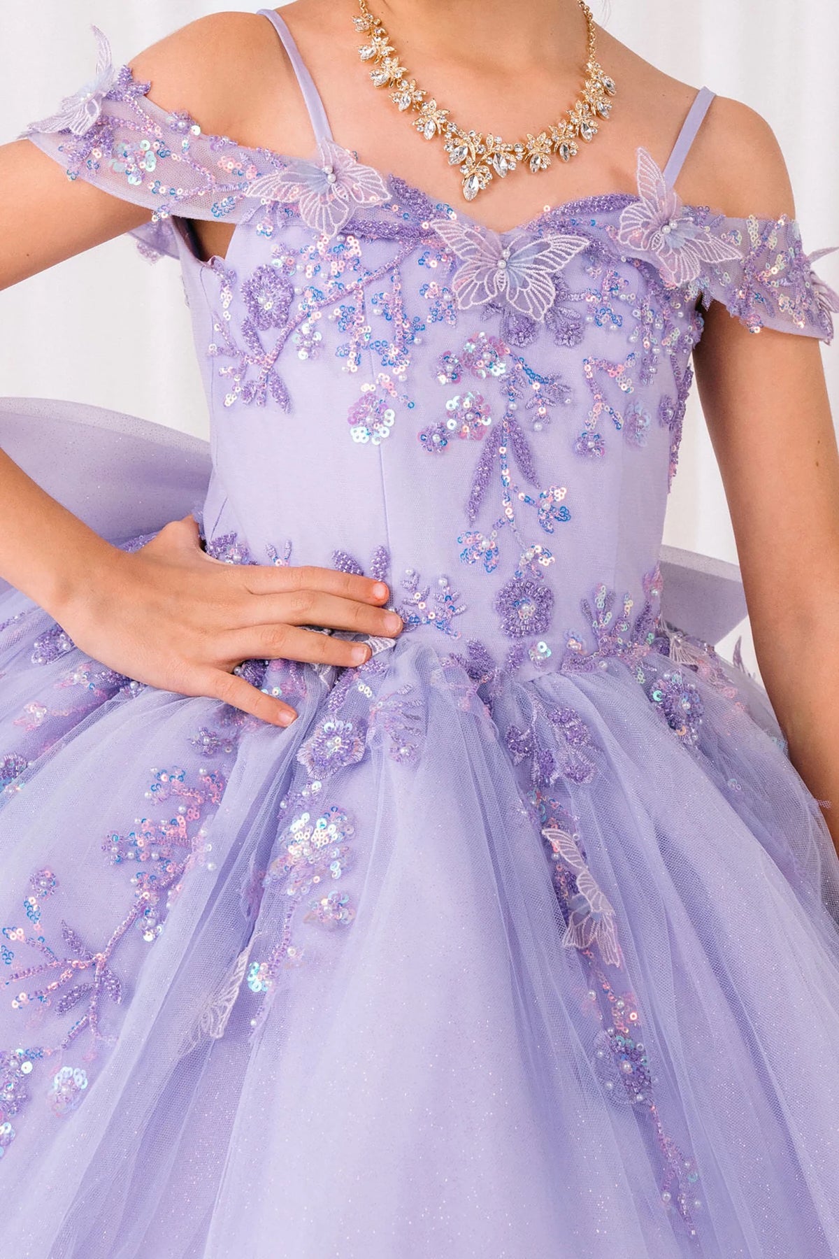 Lilac front view kids mini quinceañera mini quince dress with bead embroidered butterfly applique, floral lace and sweep train.