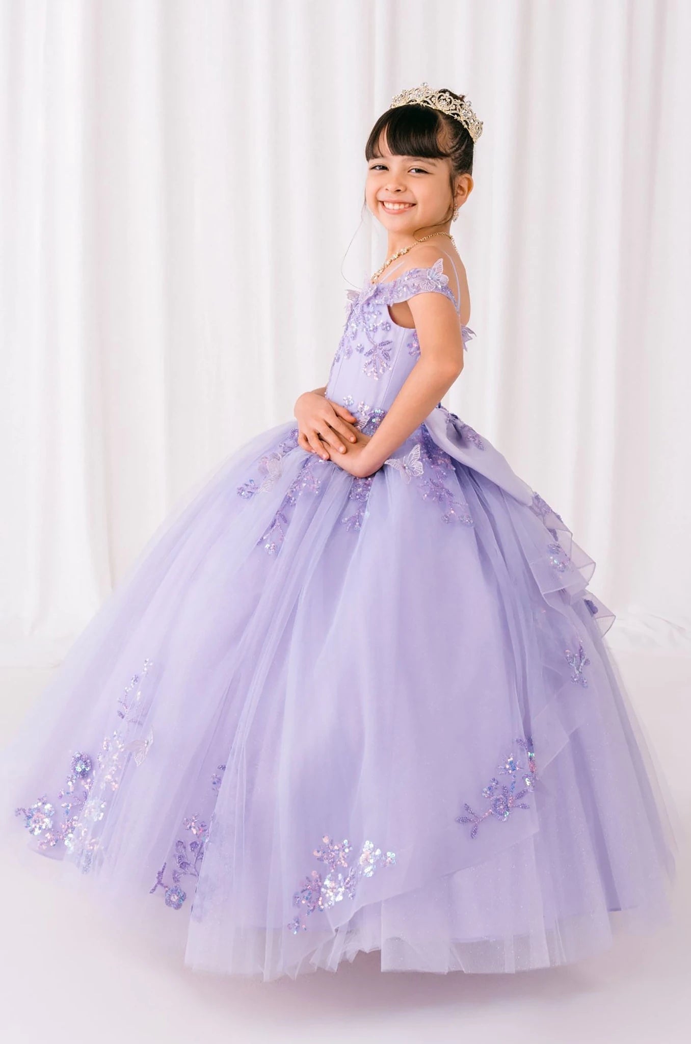 Lilac front view kids mini quinceañera mini quince dress with bead embroidered butterfly applique, floral lace and sweep train.