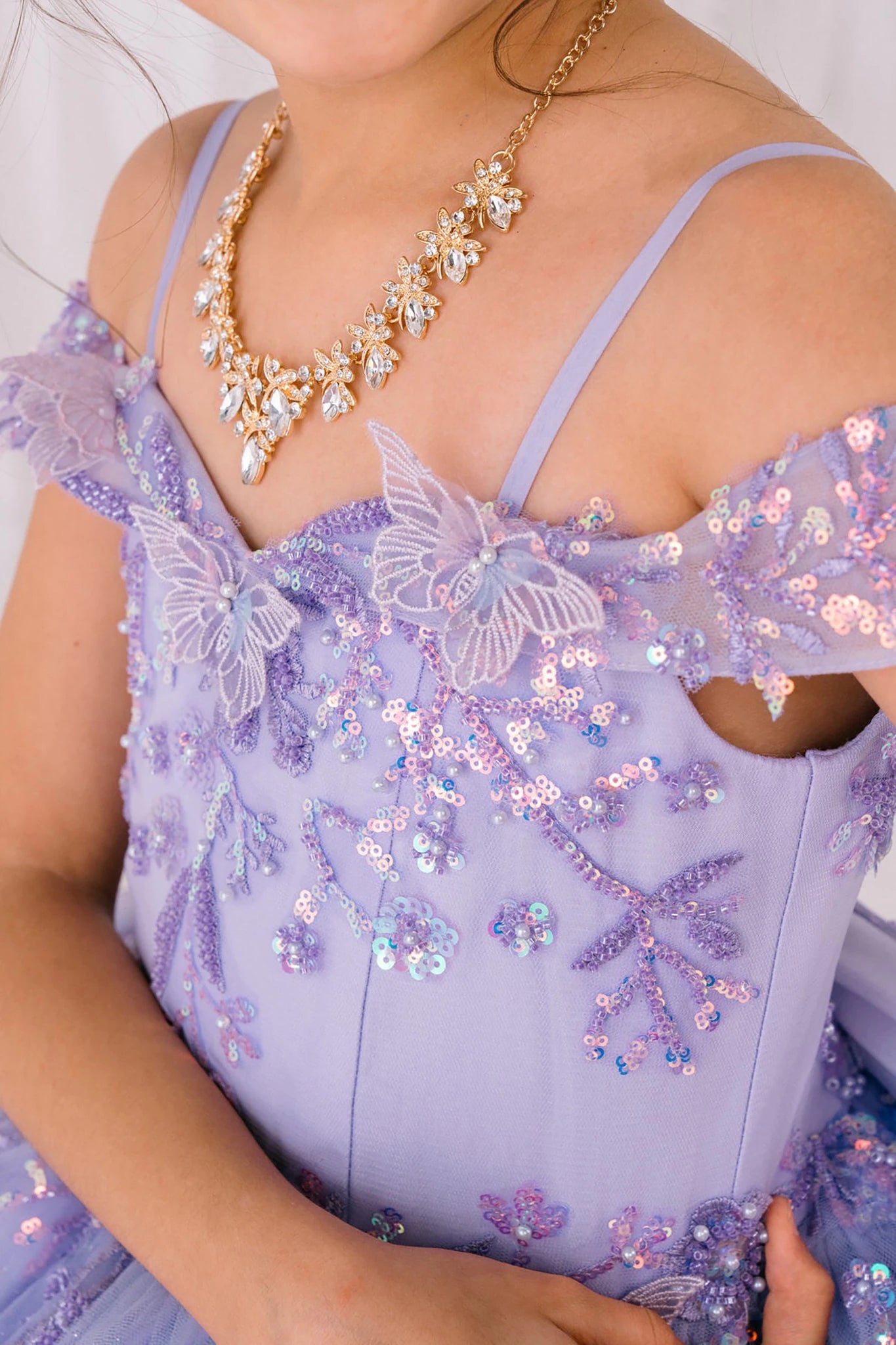 Lilac detail zoom kids mini quinceañera mini quince dress with bead embroidered butterfly applique, floral lace and necklace.