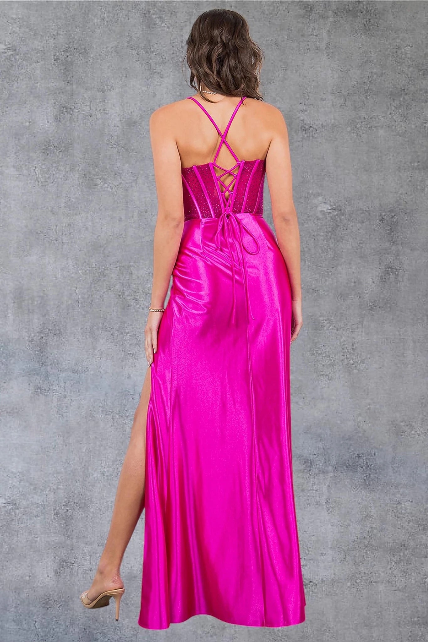 Fuchsia prom dress completed with lace-up spaghetti back and zipper closure