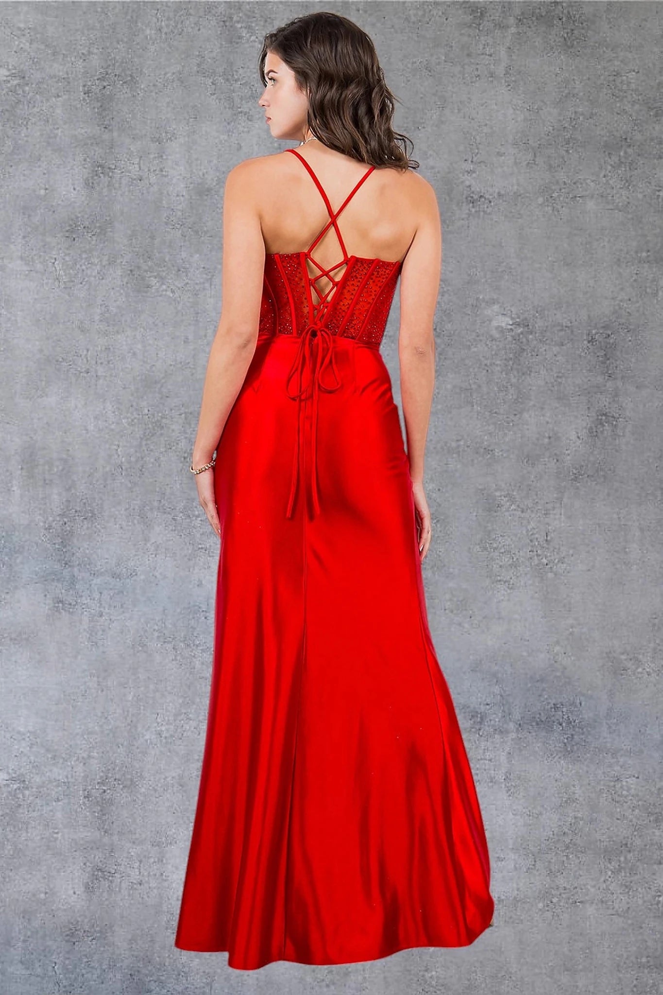 Red prom dress completed with lace-up spaghetti back and zipper closure