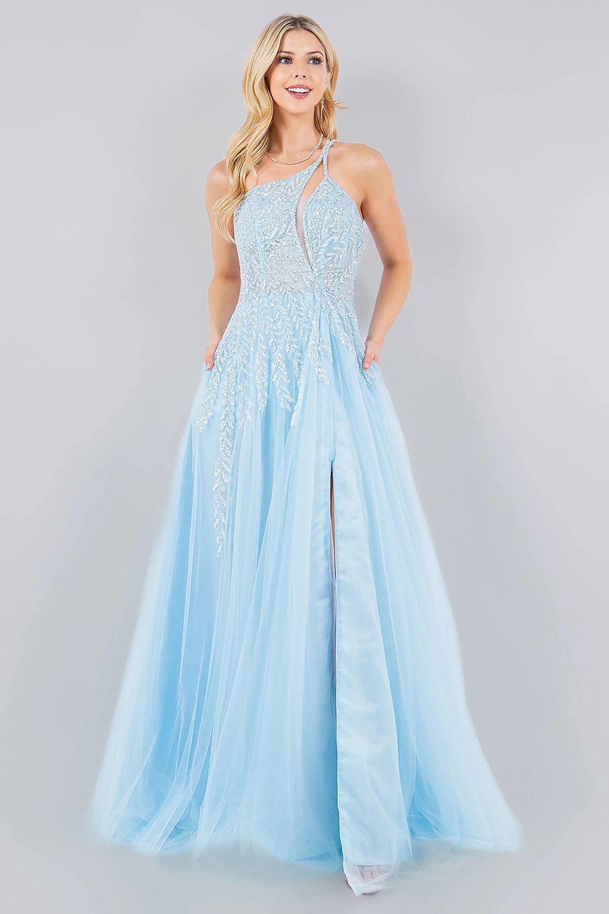 Textured details appear across blue prom dress styled with fitted A-line silhouette in layered tulle.