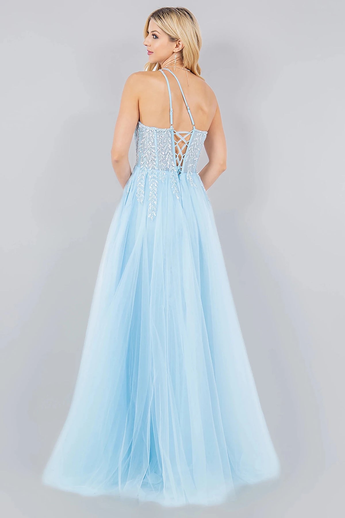 Rear view reveals blue prom dress designed with lace-up back and zipper closure.