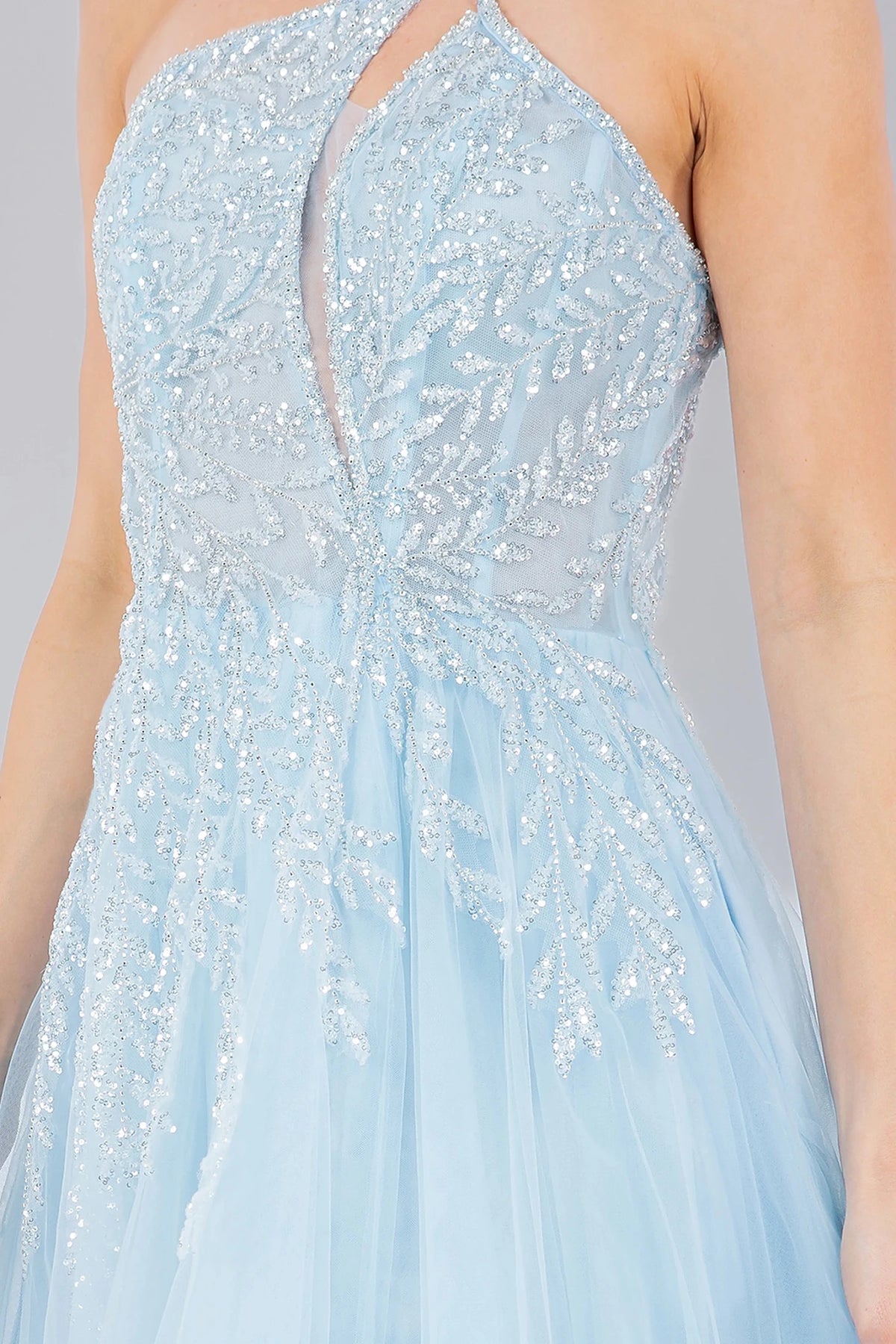 Detailed view highlights blue prom dress featuring cut-out chest detail and lace embellishments.