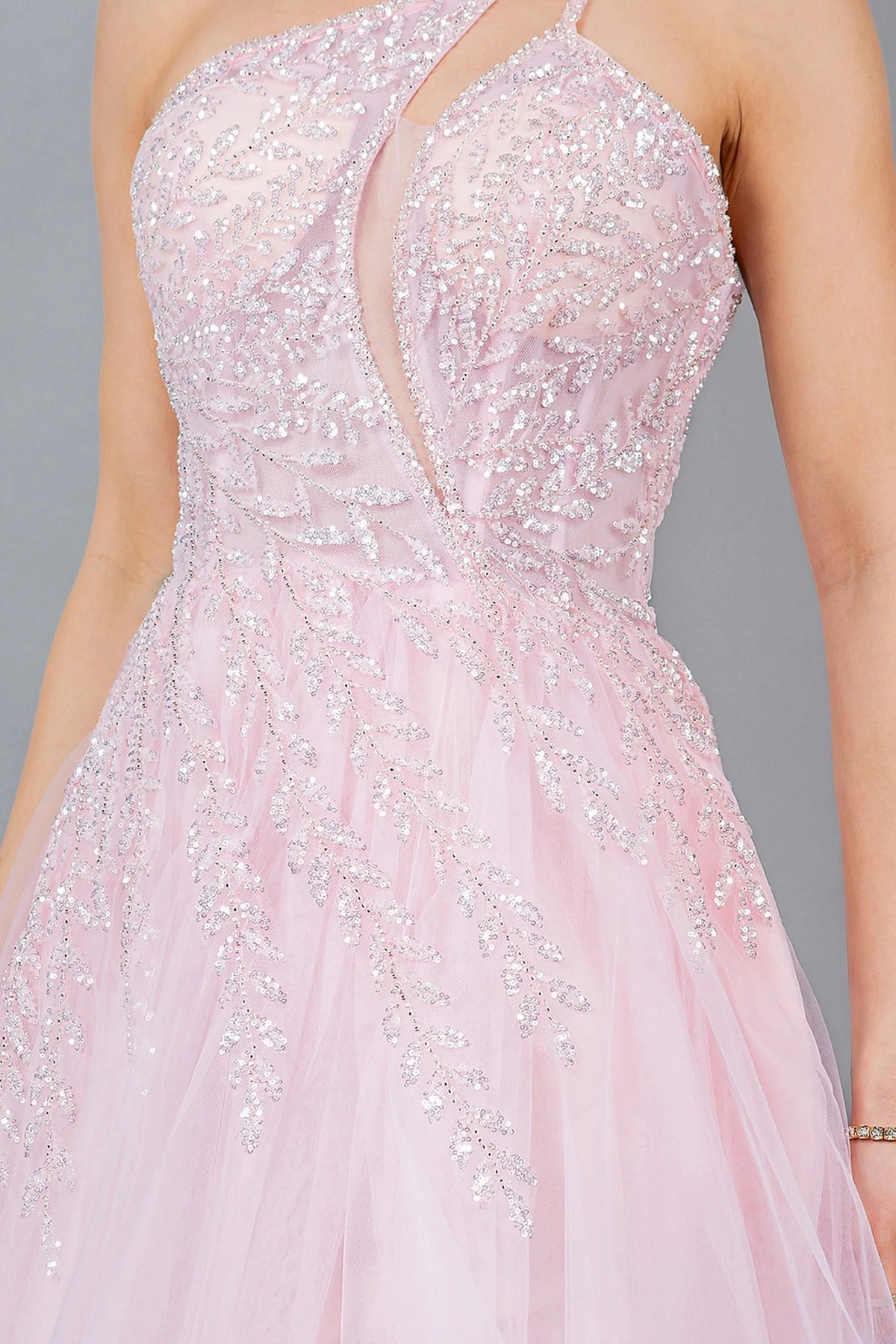 Detailed view highlights pink prom dress featuring cut-out chest detail and lace embellishments.