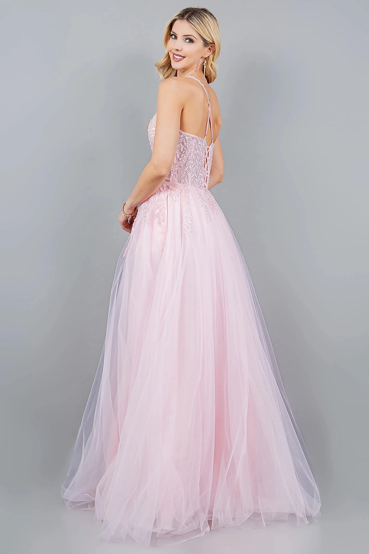 Rear view reveals pink prom dress designed with lace-up back and zipper closure.