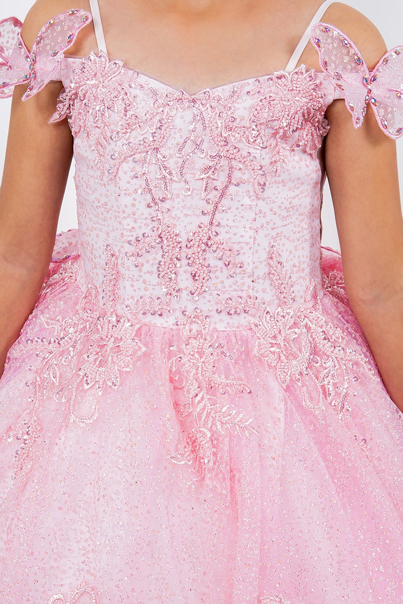 Close-up of pink mini quince dress with butterfly sleeves floral applique beaded bodice layered tulle