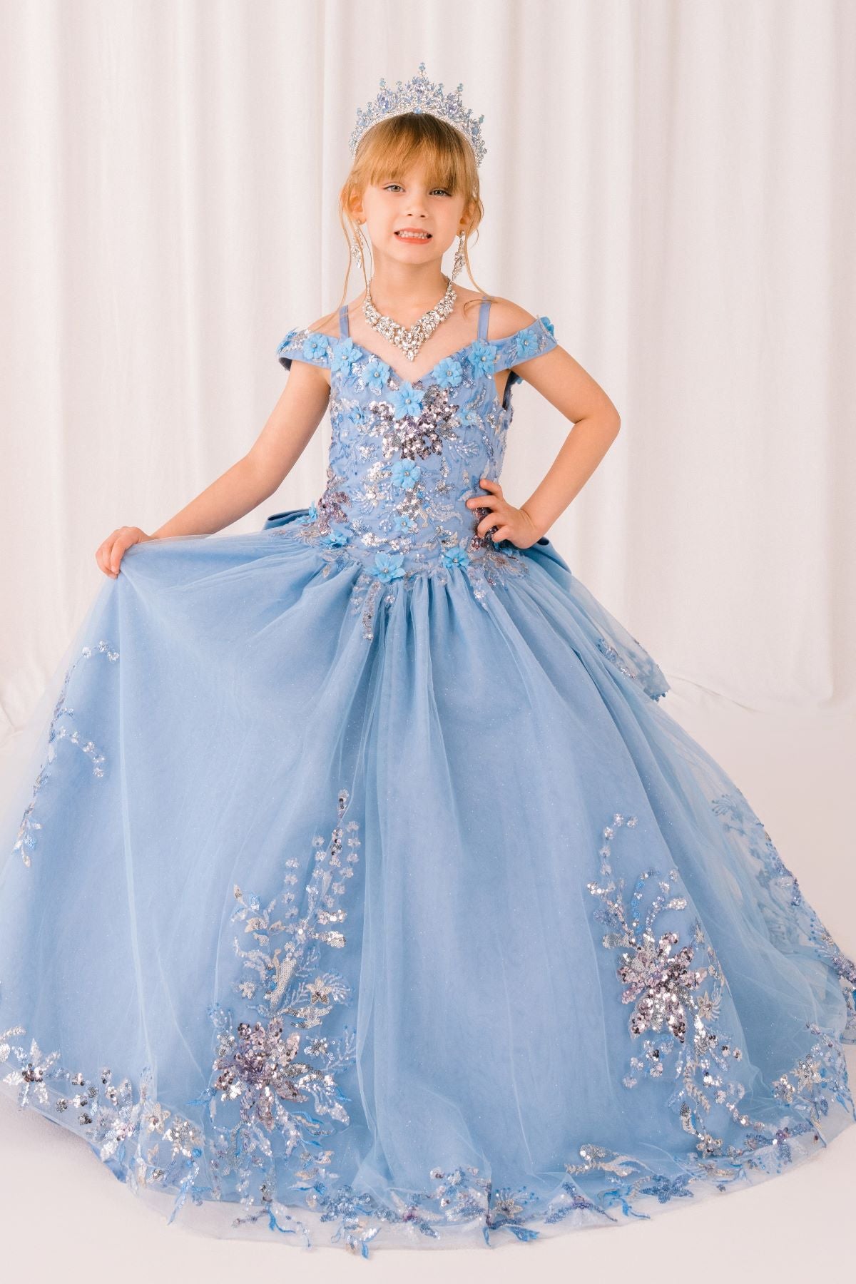 Blue front view kids mini quinceañera mini quince dress with off-shoulder 3D beaded floral applique and glitter tulle.