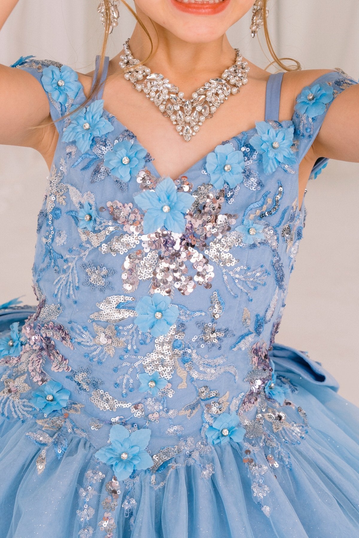 Blue front view kids mini quinceañera mini quince dress with floral lace, and sequin details.
