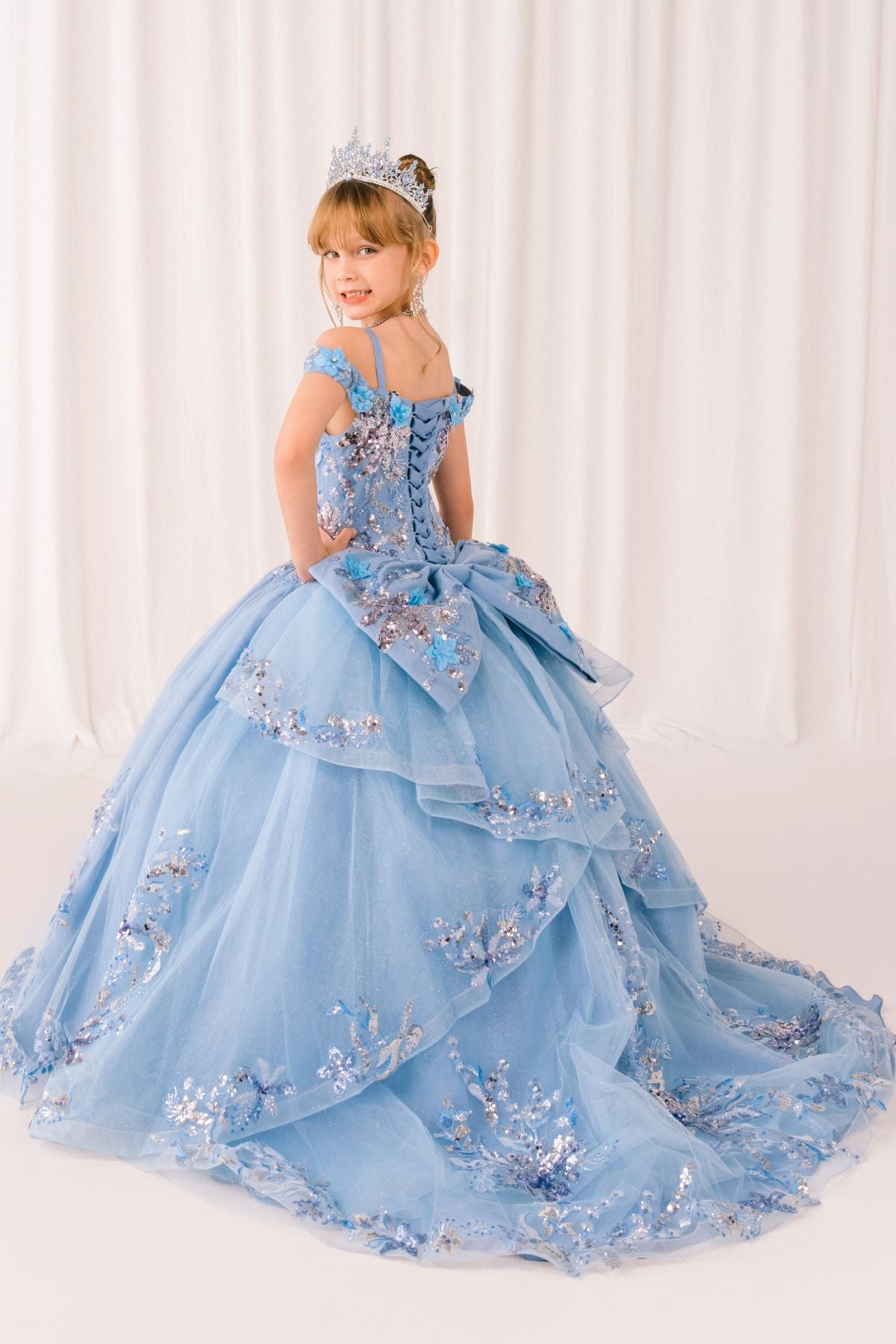 Blue front view kids mini quinceañera mini quince dress with floral lace and glitter tulle train.