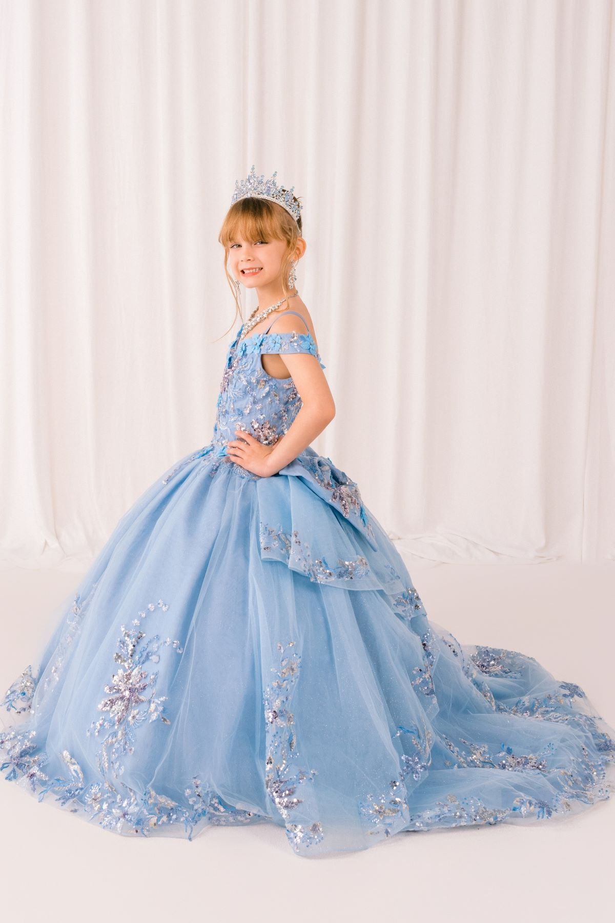 Blue front view kids mini quinceañera mini quince dress with floral lace and glitter tulle train.