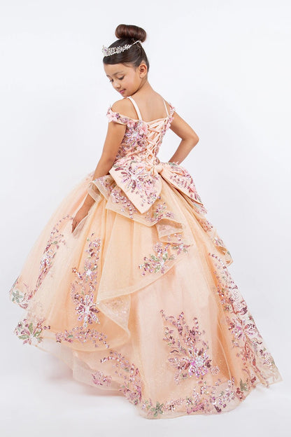 Displayed in a back view, the Peach Blush mini quince dress has lace-up back and floral bow above a tiered tulle skirt.