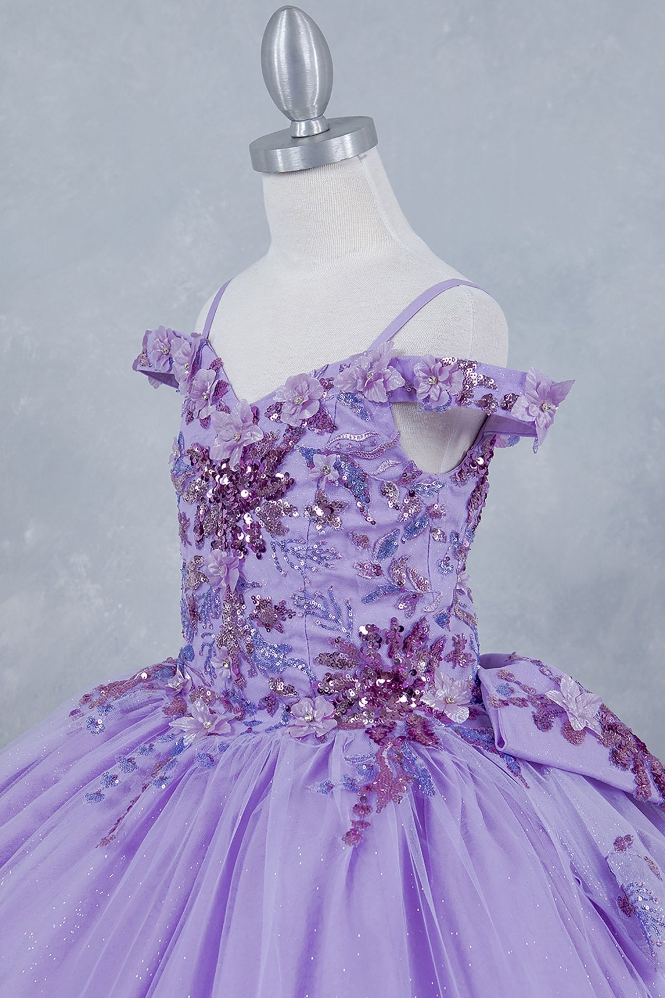 Lilac detail view kids mini quinceañera mini quince dress with off-shoulder 3D beaded floral applique, sequins and glitter tulle.